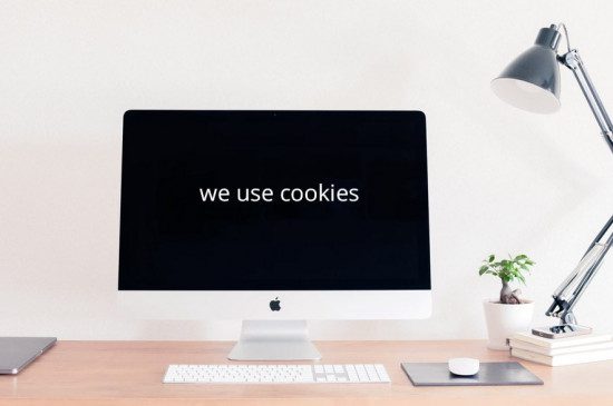 a laptop with a black screen and text: we use cookies