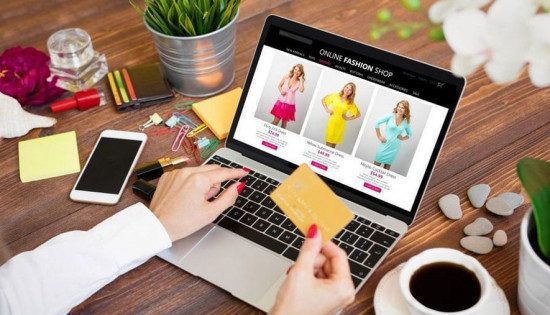 a woman sitting in front of laptop and looking for online store's dresses 